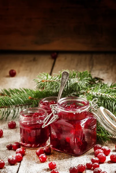 Winter cranberry sauce in glass jars — Stok fotoğraf