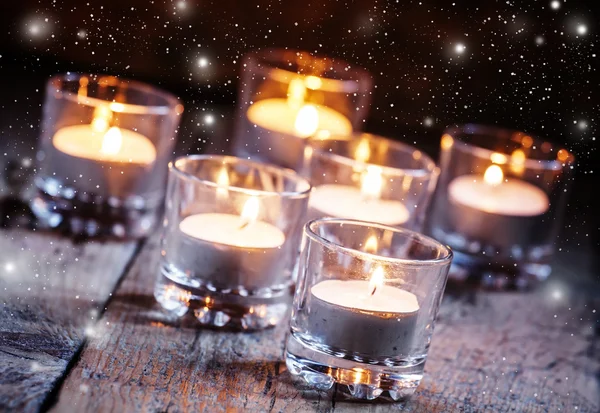 Burning small candles in glass candlesticks — Stockfoto