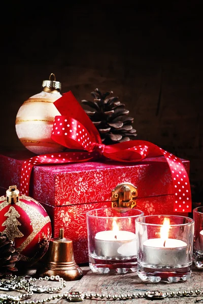 Burning candles and red box with gifts — Stok fotoğraf