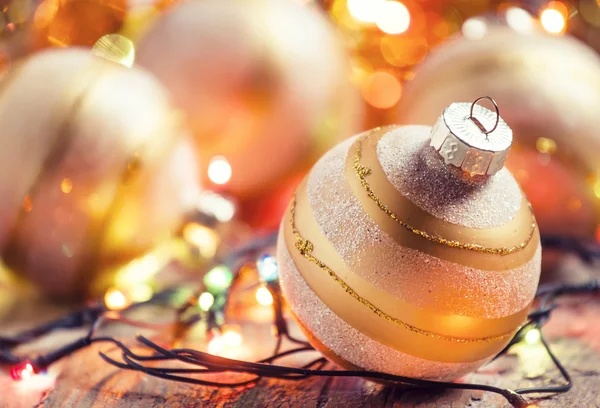 Golden Christmas tree balls and colored Christmas lights — Stock fotografie