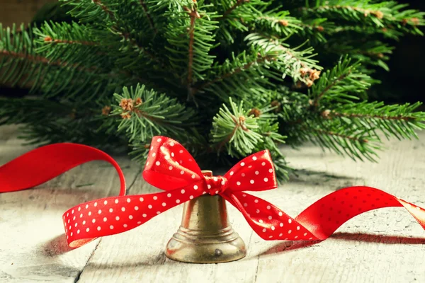 New Year or Christmas bell with a red ribbon in polka dots — Stock Photo, Image