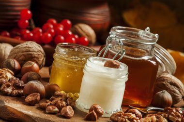 Three types of honey with walnuts and hazelnuts 