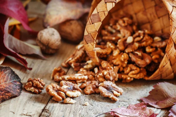 Čerstvé vlašské ořechy vypadla z proutěný koš — Stock fotografie