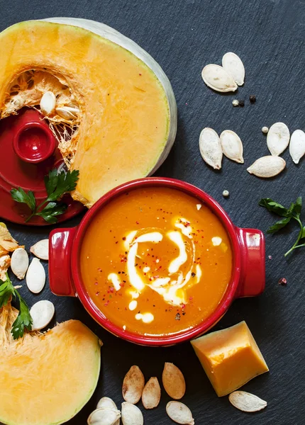 Pumpkin soup with sour cream in a saucepan — Stock Image Pumpkin soup with sour cream in a saucepan Royalty Free Stock Images