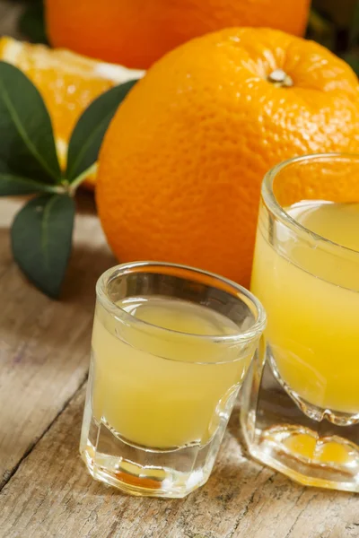 Jus d'orange frais dans un grand et un petit verre — Photo