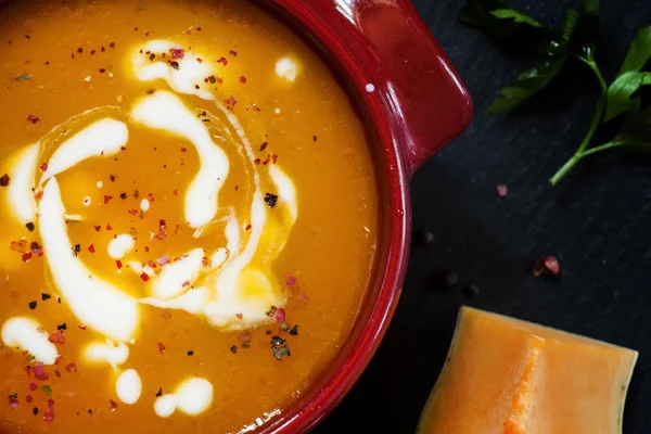 Pumpkin soup with sour cream in a saucepan — Stock Image Pumpkin soup with sour cream in a saucepan Stock Image