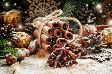 Christmas decoration with cinnamon, anice, pine cones and spruce branches