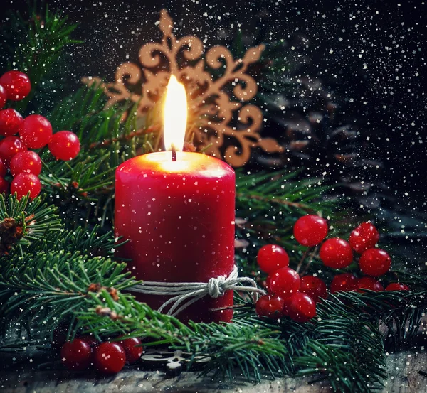 Christmas or New Year's dark composition with burning red candle — Stock Photo, Image