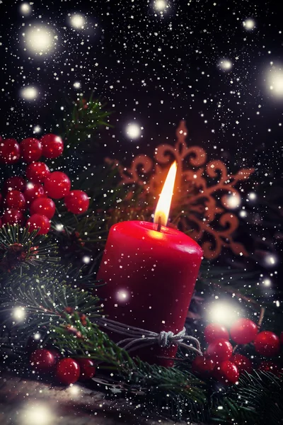 Christmas or New Year's dark composition with burning red candle — Stock Photo, Image