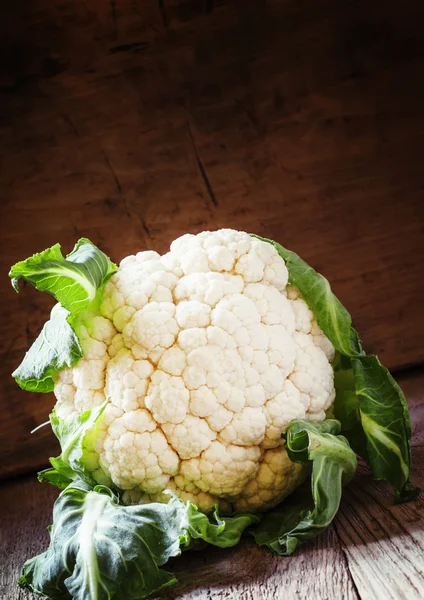 Fresh cauliflower with leaves on a vintage wooden background — Stock Photo, Image