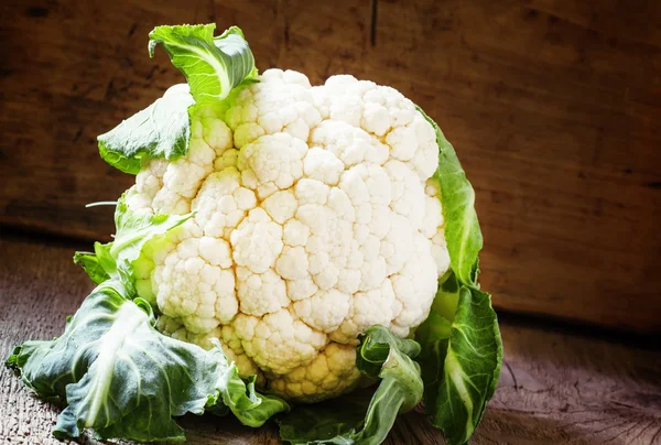 Fresh cauliflower with leaves on a vintage wooden background — Stock Photo, Image