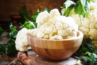 Inflorescences of cauliflower in a wooden bowl clipart