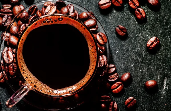 Glass cup of espresso coffee with foam, roasted coffee beans — Stock Photo, Image