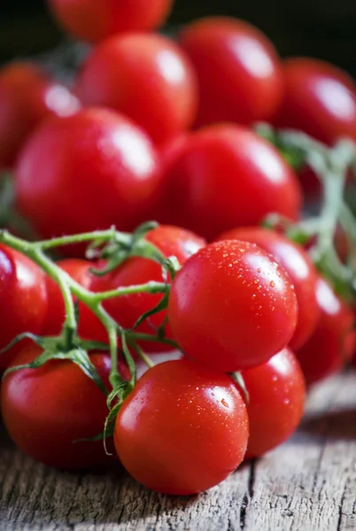 Cherry tomatoes on vintage wooden background — Stock Photo, Image