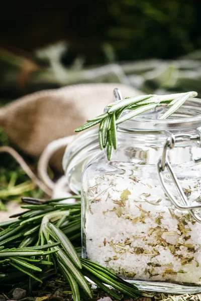 Sea salt with dried rosemary in a glass jar — Stock Photo, Image