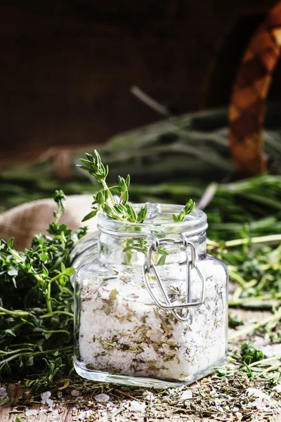 Traditional spicy salt with thyme in a glass jar — Stock Photo, Image