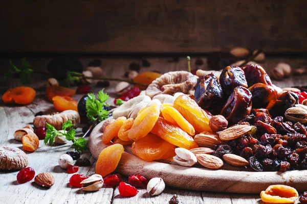 Dried apricots, dates, raisins and various nuts — Stock Photo, Image