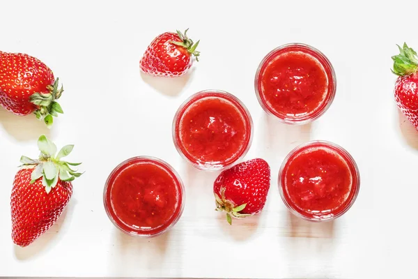 Strawberry juice on white wooden background — Stock Photo, Image