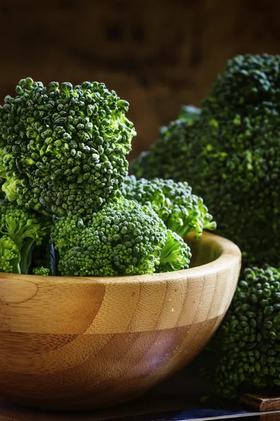 Chunks of broccoli in a wooden bowl — Stock Photo, Image