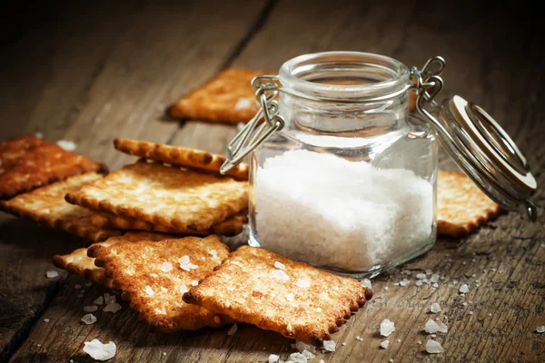 Salty crackers and sea salt in a pot — Stock Photo, Image