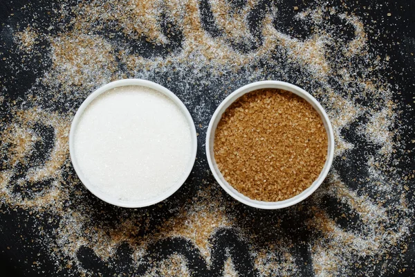 Cane and white sugar in a porcelain bowls — Stock Photo, Image