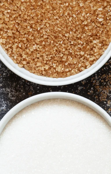 Cane and white sugar in a porcelain bowls — Stock Photo, Image