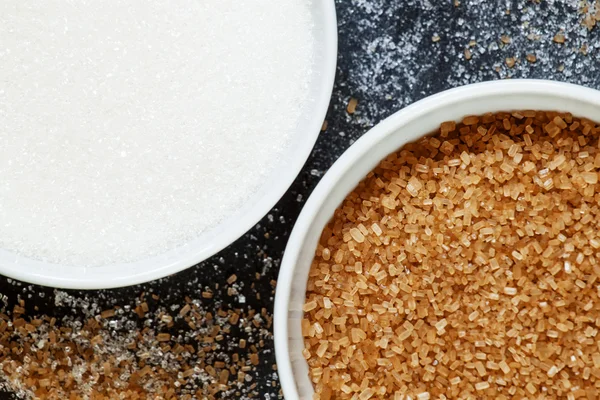 Cane and white sugar in a porcelain bowls — Stock Photo, Image