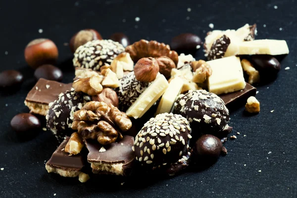 Chocolates, sweets, hazelnuts and walnuts — Stock Photo, Image