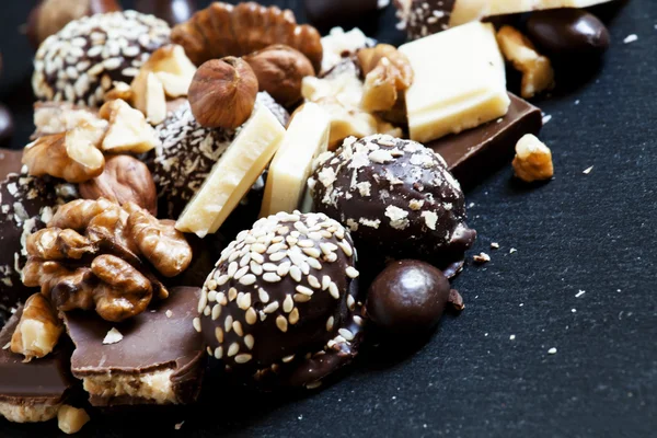 Chocolates, sweets, hazelnuts and walnuts — Stock Photo, Image