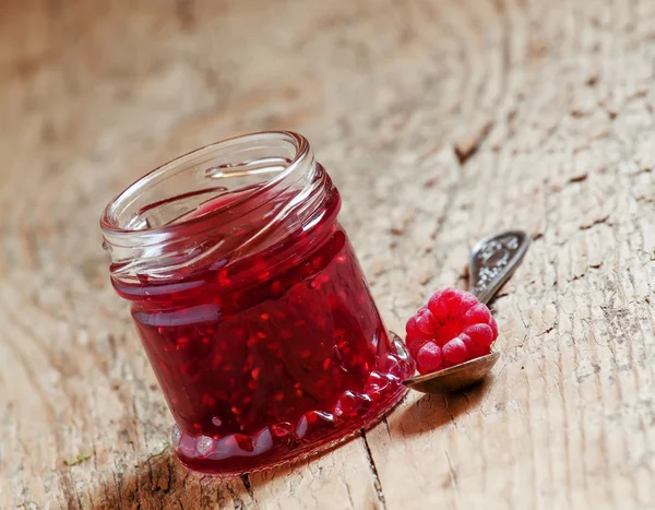 Raspberry jam in a jar and raspberry in a spoon — Stock Photo, Image