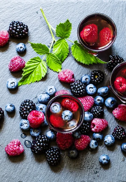Juice of wild berries on a dark background