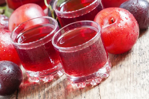 Delicious fresh juice of red and blue sweet plums — Stock Photo, Image