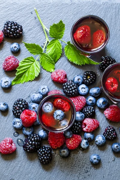 Juice of wild berries on a dark background