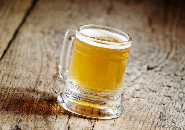 Light beer in a little old-fashioned mug — Stock Photo, Image