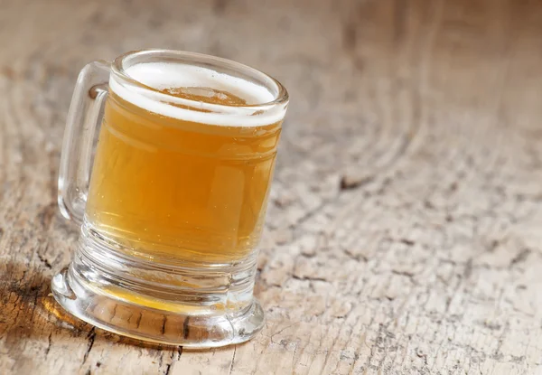 Light beer in a little old-fashioned mug — Stock Photo, Image