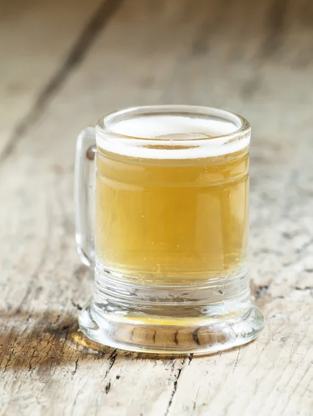Light beer in a little old-fashioned mug — Stock Photo, Image
