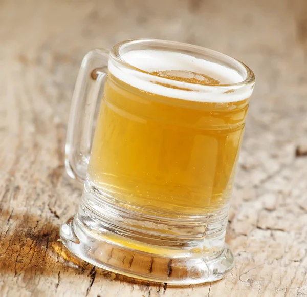 Light beer in a little old-fashioned mug — Stock Photo, Image