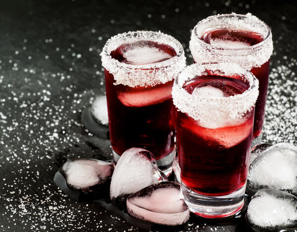 Red cocktail in glasses decorated with sugar
