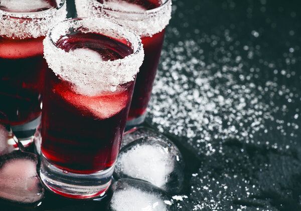 Red cocktail in glasses decorated with sugar