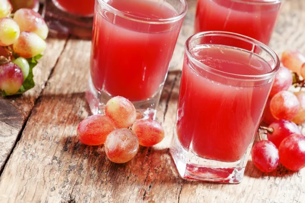 Grape juice pink grapes with fresh berries