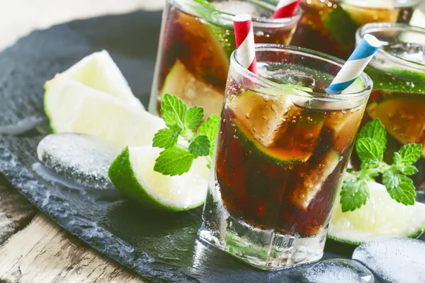Cuba Libre with lime, mint and ice in a glasses — Stock Photo, Image
