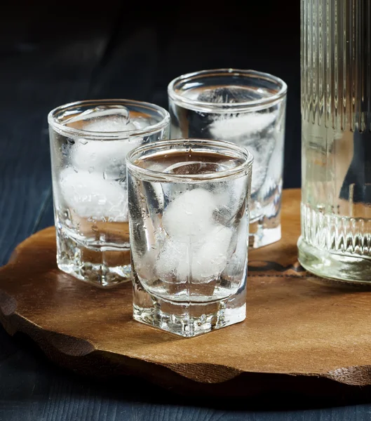 Fles wodka en de glazen vol met ijs — Stockfoto