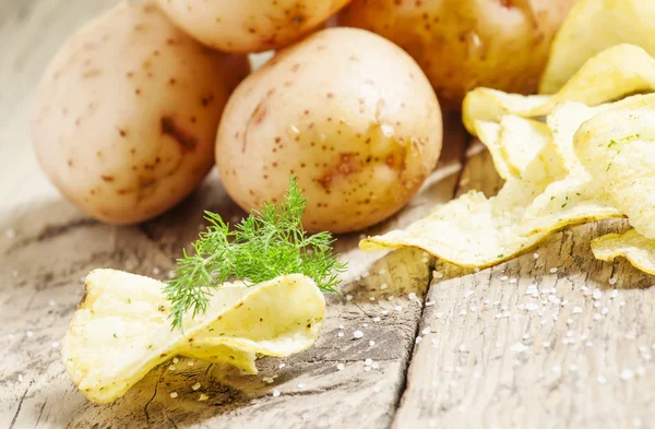 Verse aardappelen en aardappelchips — Stockfoto