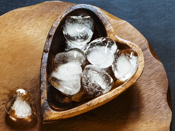 Heart of ice in a wooden bowl — Stock Photo, Image