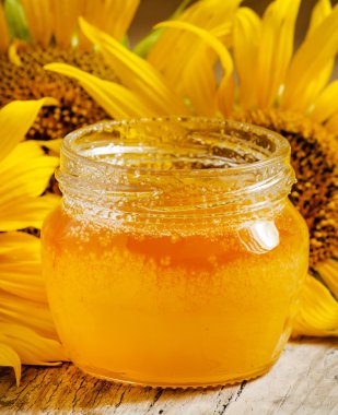 Bal ve ayçiçeği ahşap bir masa üzerinde