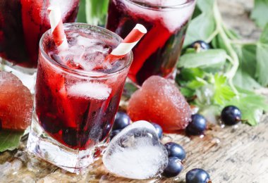 Çilek ve buz bir kalp şeklinde taze blackcurrant içkiyle