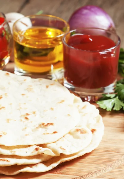 Homemade tortilla on the board with vegetables — Stock Photo, Image