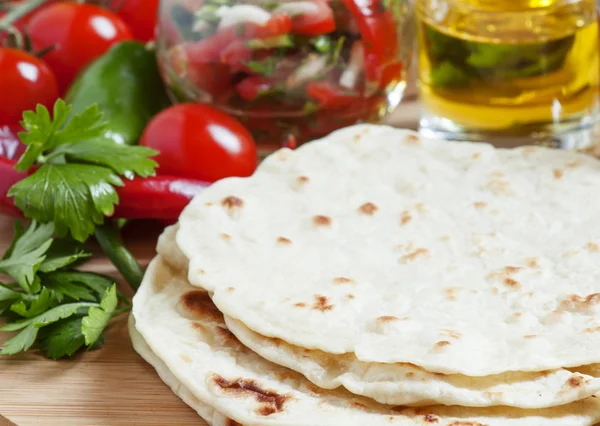 Homemade tortilla on the board with vegetables — Stock Photo, Image
