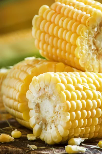 Pieces of corn cobs on vintage wooden table — Stock Photo, Image