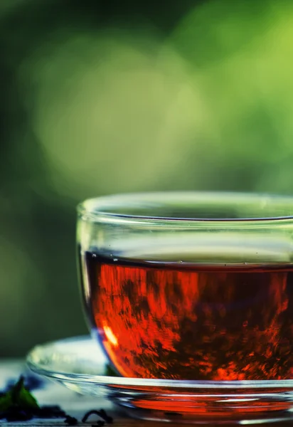 Cup of black tea on the open window — Stock Photo, Image